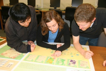 Students inspecting a plotted GIS map.